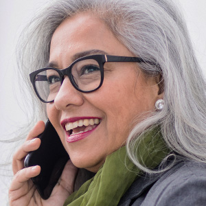 mature woman wearing eye glasses on the phone