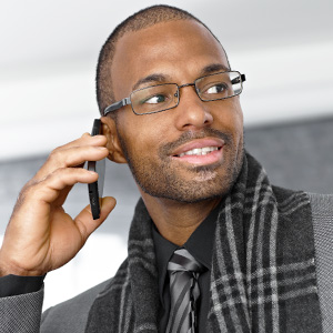 young business man wearing eye glasses while on his smart phone