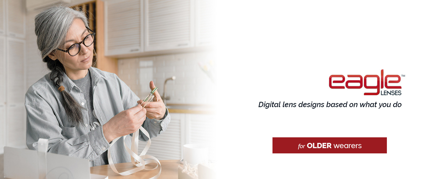 mature asian woman wearing glasses working on crafts